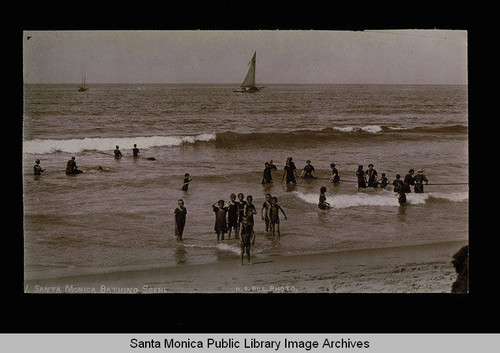 Bathers in surf and sailboat