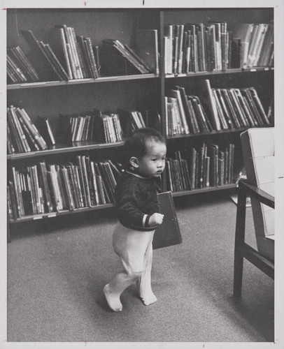 Toddler holding a book