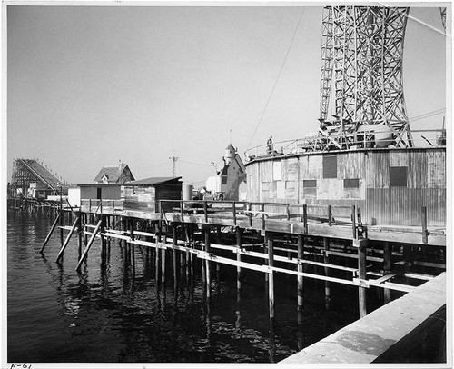 West facing view of Ocean Park Pier's Strat-O-Liner (later the Mr. Dolphin ride at POP), Kiddy Town, and the site which would become the Mystery Island Banana Train ride at Pacific Ocean Park, Santa Monica, Calif