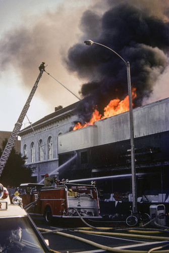 Firefighters battling a blaze at Thrifty Drug Store at 326 Wilshire Blvd