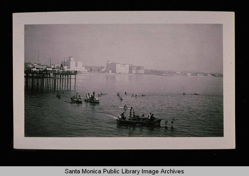 Surfer's festival with the Breakers, Edgewater and Del Mar beach clubs in distance, Santa Monica, Calif