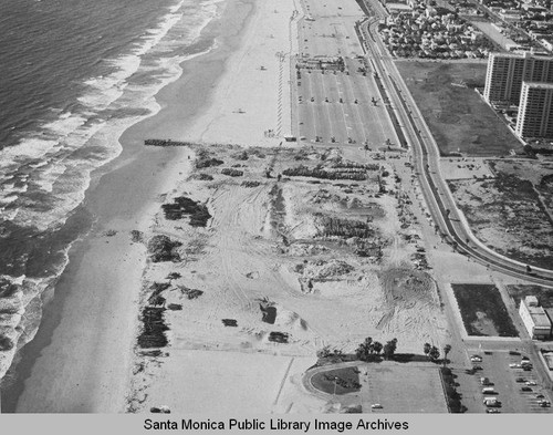 Looking north from the remains of the Pacific Ocean Park Pier to the Santa Monica Shores Apartments and beach parking lots, March 27, 1975, 2:00PM