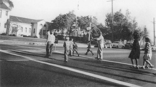 Crossing Guard with school children on Santa Monica Blvd. in Santa Monica, Calif