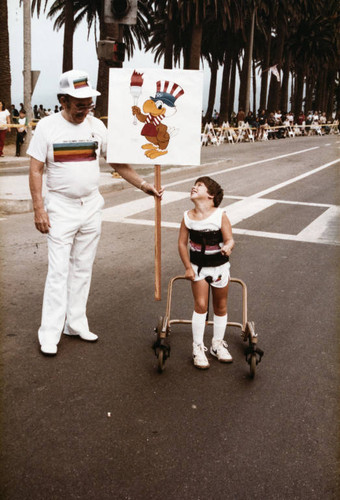 Seven-year-old Michael Bailey ready to take the Olympic torch over from O.J. Simpson on July 21, 1984, Santa Monica, Calif