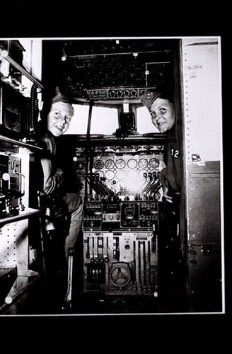 Two visiting Boy Scouts in the cockpit of a plane at the Douglas Santa Monica plant