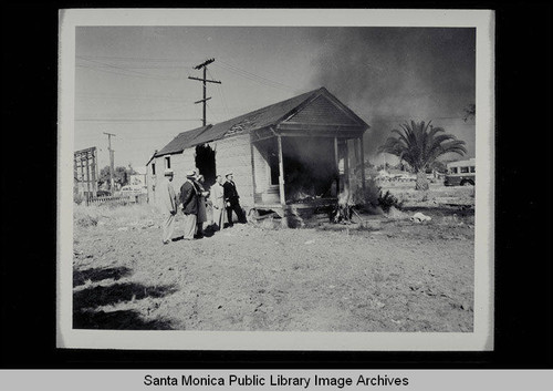 Burning a derelict house on Belmar Place between Main and Third Streets, north of Pico, on July 1, 1953