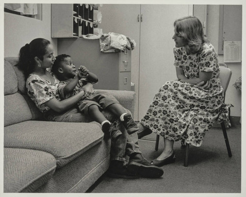 Staff meeting with a mother and her child at an unknown agency