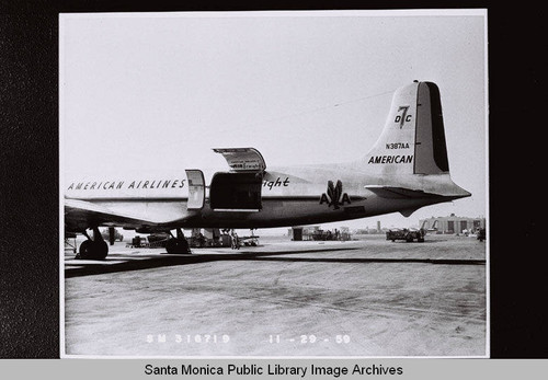 American Airlines Douglas Aircraft Company DC7 (N387AA) with freight door open, November 29, 1959