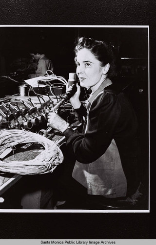 Douglas Aircraft Company Santa Monica plant employee working with wire during World War II