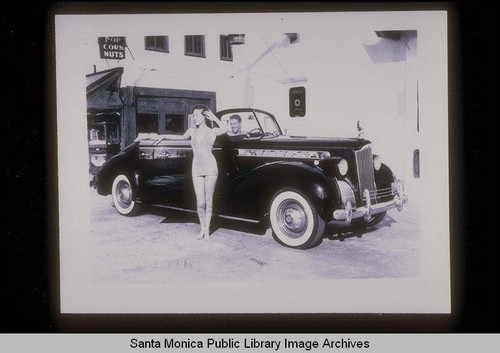 Bathing beauty and Packard automobile at the Santa Monica Pier