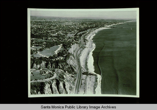 Aerial of Santa Monica Bay and coastline looking south from Potrero Canyon and the Huntington Palisades to Venice, Calif. with the Lighthouse and remains of the Long Wharf in foreground, January 24, 1939