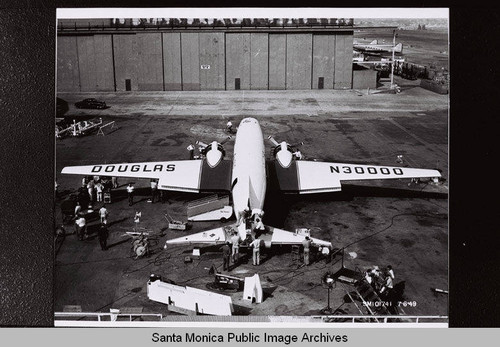 Super DC-3 (Douglas N30000) on tarmac while the tail assembly is being completed by Douglas plant employees, Santa Monica, Calif., July 6, 1949