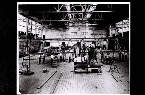 Donald W. Douglas looks at plans while employees work on the Martin Bomber at the Glen L. Martin plant