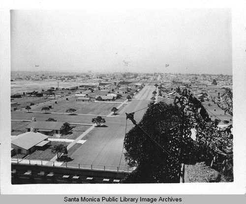 View of camouflage designed by landscape architect Edward Huntsman-Trout during World War II to cover the Douglas Aircraft Company plant at 3000 Ocean Park Blvd.,Santa Monica, Calif. with dirigibles (airships) hovering over the burlap neighborhood