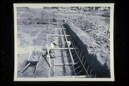 Construction of the Santa Monica Municipal Pool, finishing surface of swim pool footings, July 25, 1950