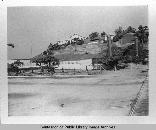 Dirigible (airship) hovers over camouflage neighborhood designed by landscape architect Edward Huntsman-Trout to cover the Douglas Aircraft Company Santa Monica plant and conceal the manufacture of military aircraft during World War II