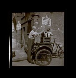 Two men loading Texaco bottles, Shanghai, China