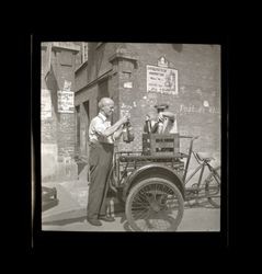 Two men loading Texaco bottles, Shanghai, China