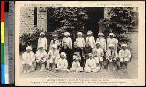Missionaries seated with a gathering of people, India, ca.1920-1940