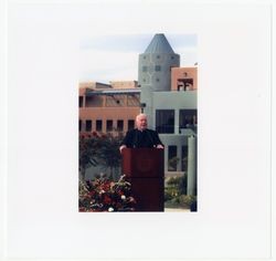 Thomas O' Malley, S.J., giving speech in front of O' Malley Student Apts