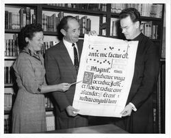 Theodore Marshall, S.J., Dorothy O'Malley, and Stanley Slotkin (center) presenting a medieval antiphonal leaf