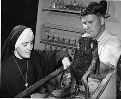 Mother Stanislaus and John Prescott looking at an octopus