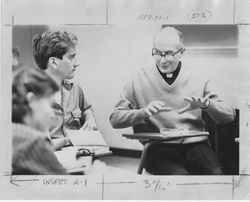 Clinton E. Albertson, S.J., in classroom with students