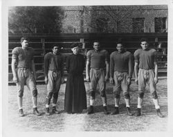 Patrick Conway, S.J., and Loyola football players