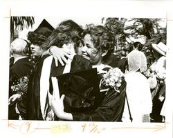 Students hugging at Loyola Marymount University commencement, 1980