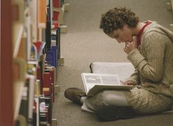 Student reading in library