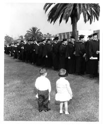 Children watching graduation procession