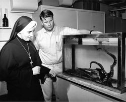 Mother Stanislaus and John Prescott looking at an octopus