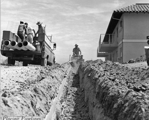 Placing pipelines during Leisure World (Laguna Woods) manor construction, 1960s