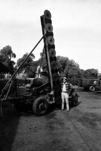 Circular saws used to clear paths between the orange trees to accommodate spraying rigs, Tustin, ca. 1960