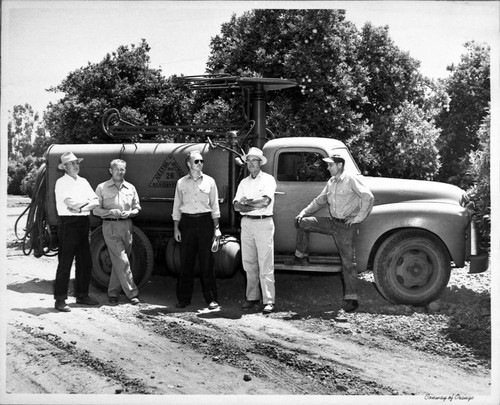 Graves & Howley spray truck rig with Bill Graves, Theron Willis, Ortho tech. rep. Paul Andres, and head mechanic Ernie Dargatz, Tustin, ca. 1960