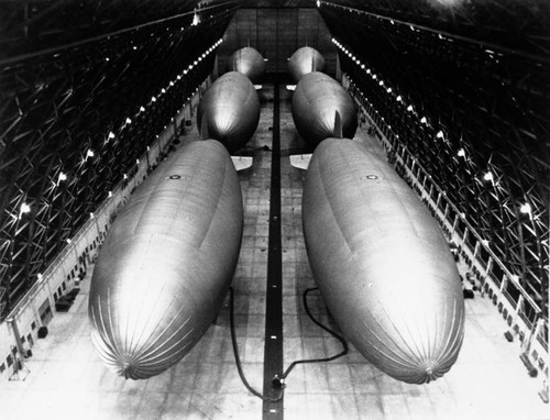 Interior view of a hangar showing six airships (blimps), Lighter Than Air (LTA) Base, Tustin, ca. 1960