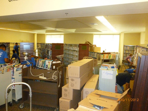 Laguna Niguel Library putting books back on the shelves in the Children's area, August 11, 2012