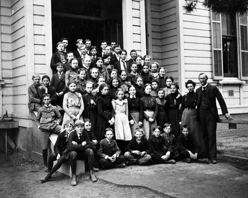 Tustin Public School students with Principal John J. "Zeke" Zielian on the front steps of the school, ca. 1905