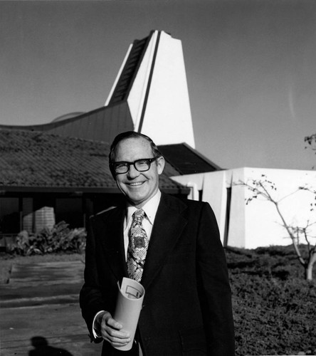 Dr. Ivan B. Bell stands in front of Leisure World's First Baptist Church