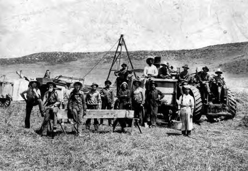 Farm workers and equipment in field