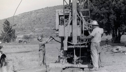 Alice Chandler helping Mr. Smith drill a well