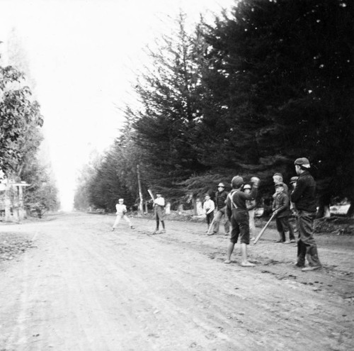 Boys playing baseball on Main Street in Tustin, 1909