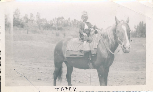 Child riding horse on Chandler Ranch