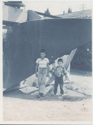 Mike and Jon Hennig with giant plow in Huntington Beach, 1952