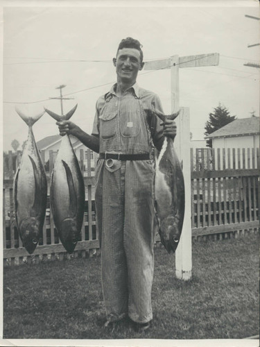 Sam Hennig holding fish in Huntington Beach, 1943