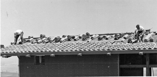 Placing roof tiles during Leisure World manor construction, 1960s