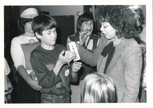 Elizabeth Martinez Smith, County Librarian, at the hamster races at the library, 1983