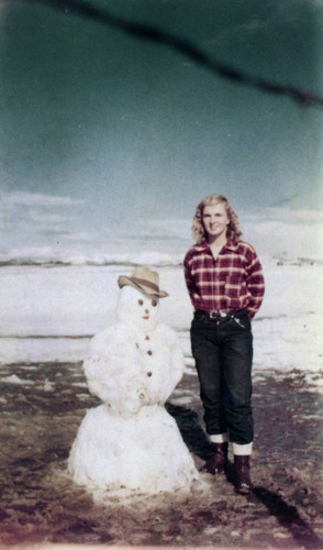 Alice Chandler with snowman on Peters Lake after snowfall