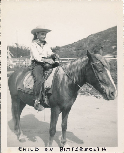 Child riding "Butterscotch"