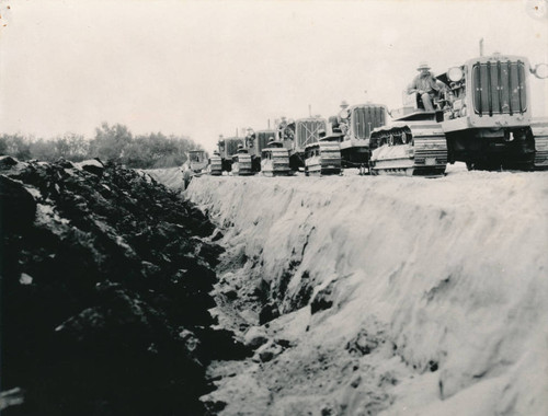 Tractors pulling world's largest plow, Westminster, 1930